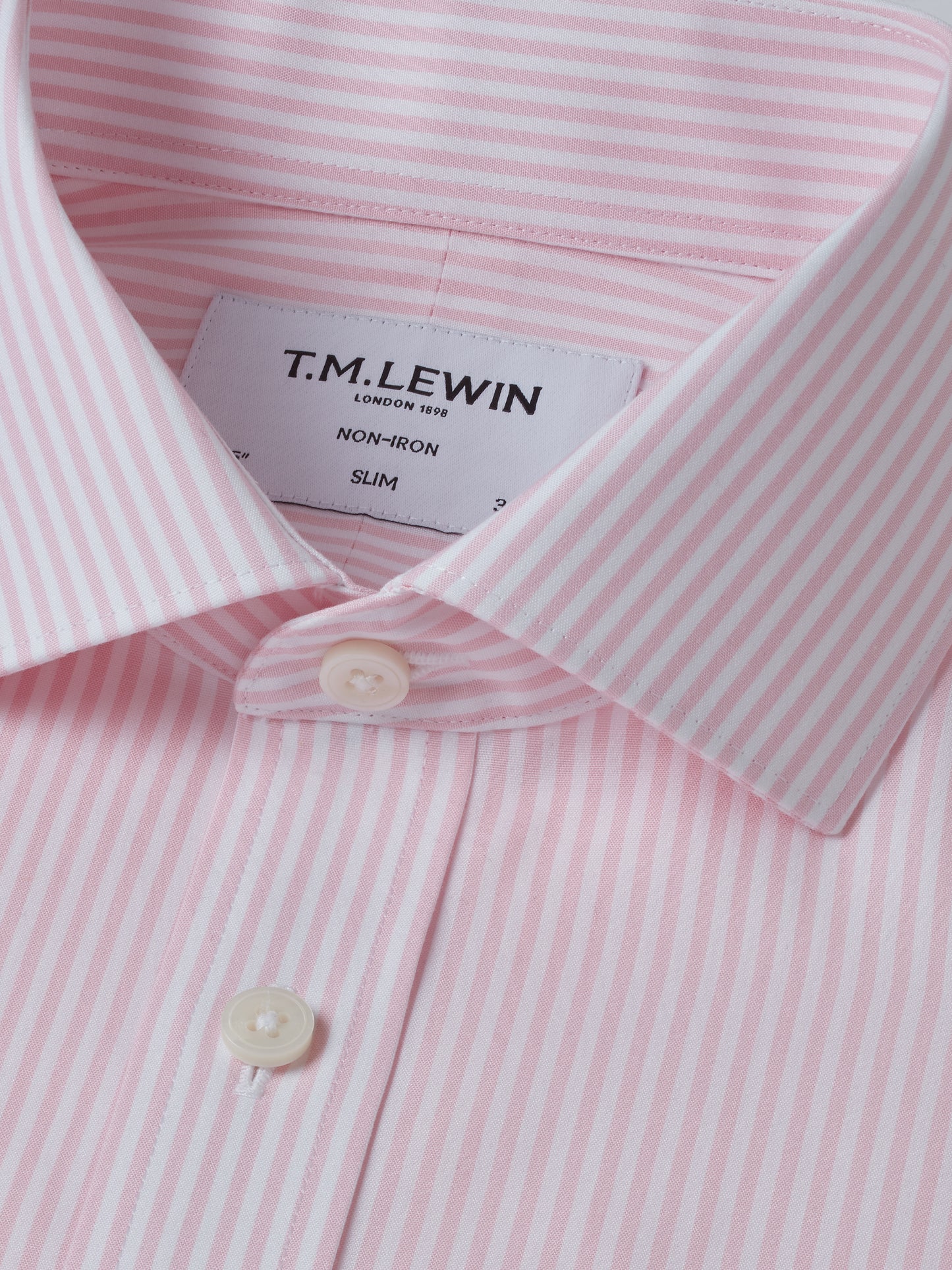 Close-up of a pink and white striped shirt with T.M. Lewin label.