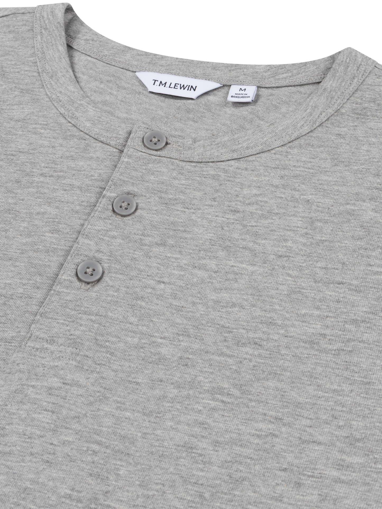 Close-up shot of the placket buttons on a grey Henley shirt's neckline