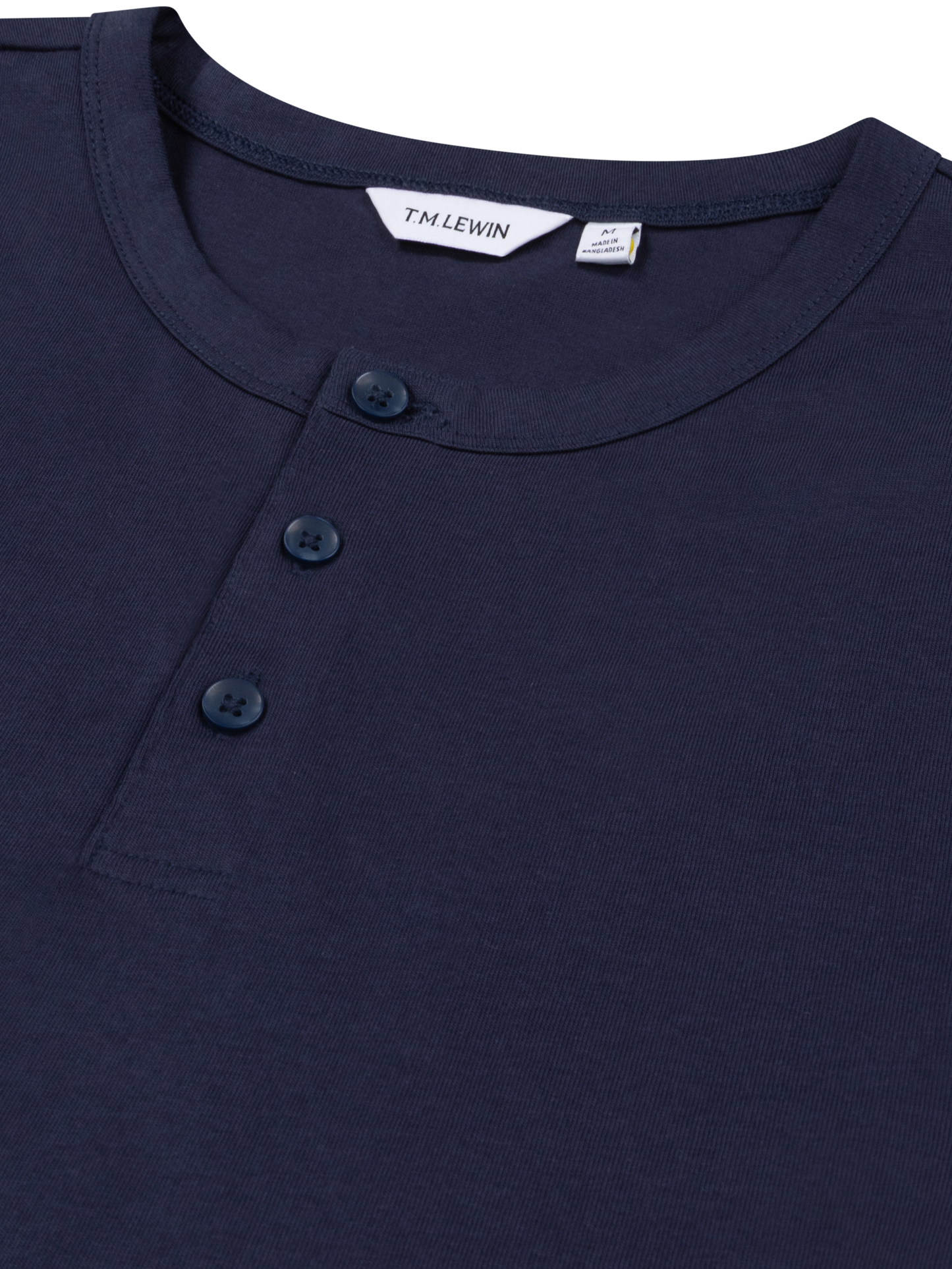 Close-up shot of the placket buttons on a navy blue Henley shirt's neckline