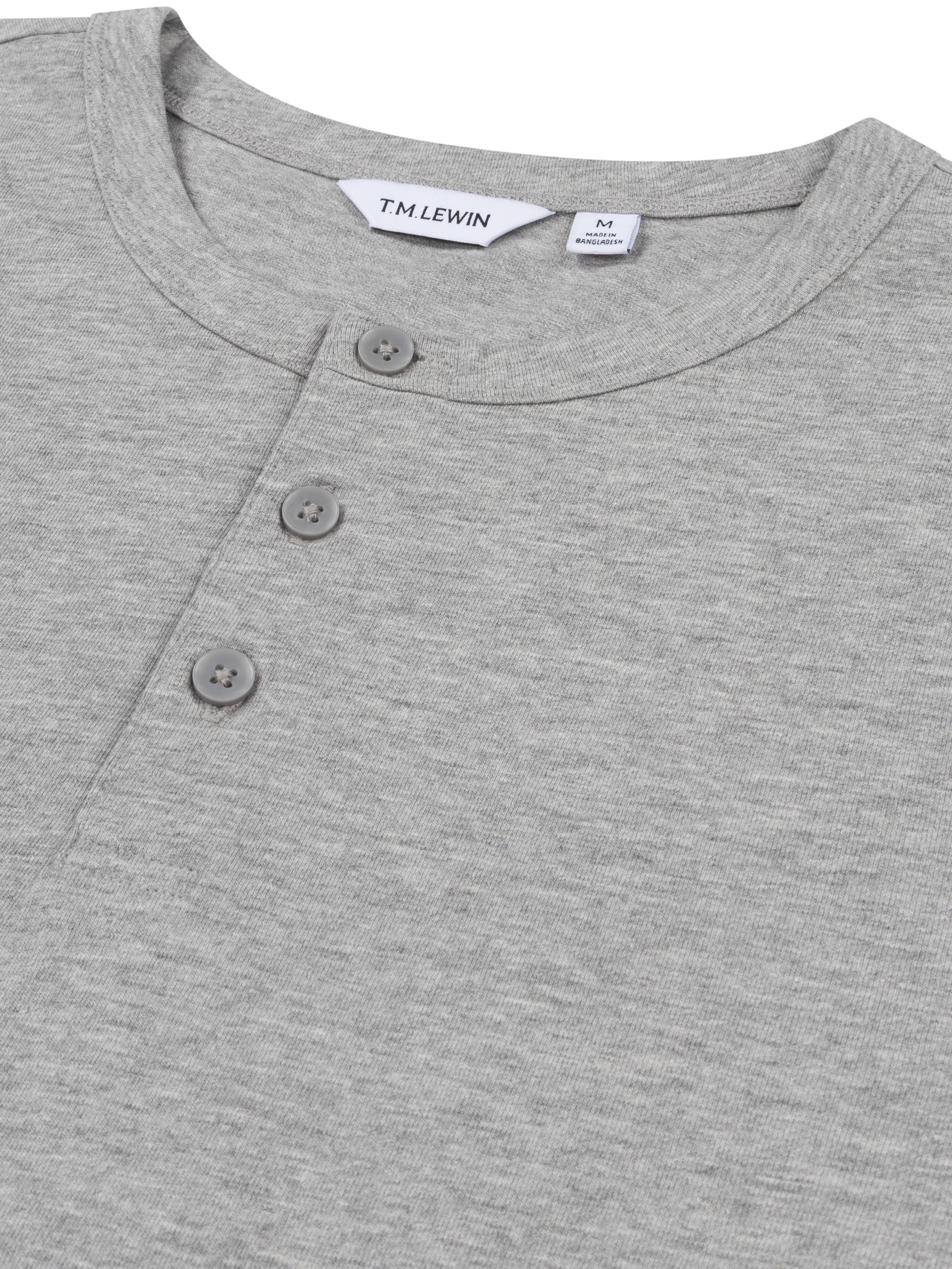 Close-up shot of the placket buttons on a grey Henley shirt's neckline